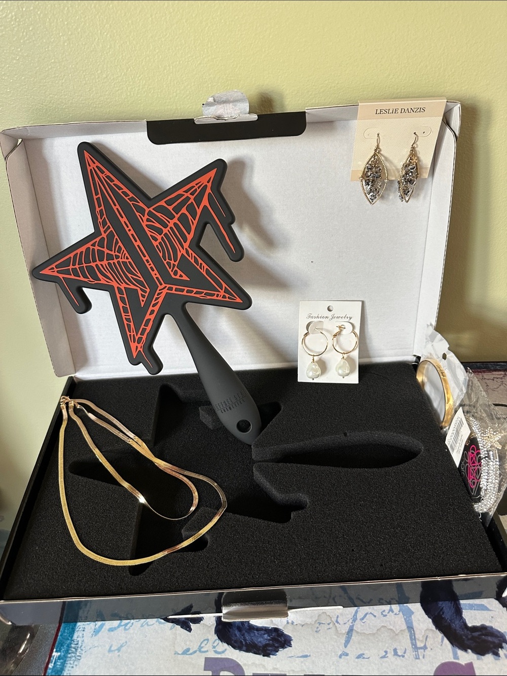 Jeffree Star hand mirror and jewelry